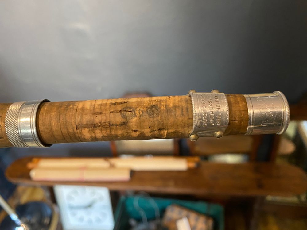 A Hardy oak and iron bound case containing three Hardys split cane fishing rods